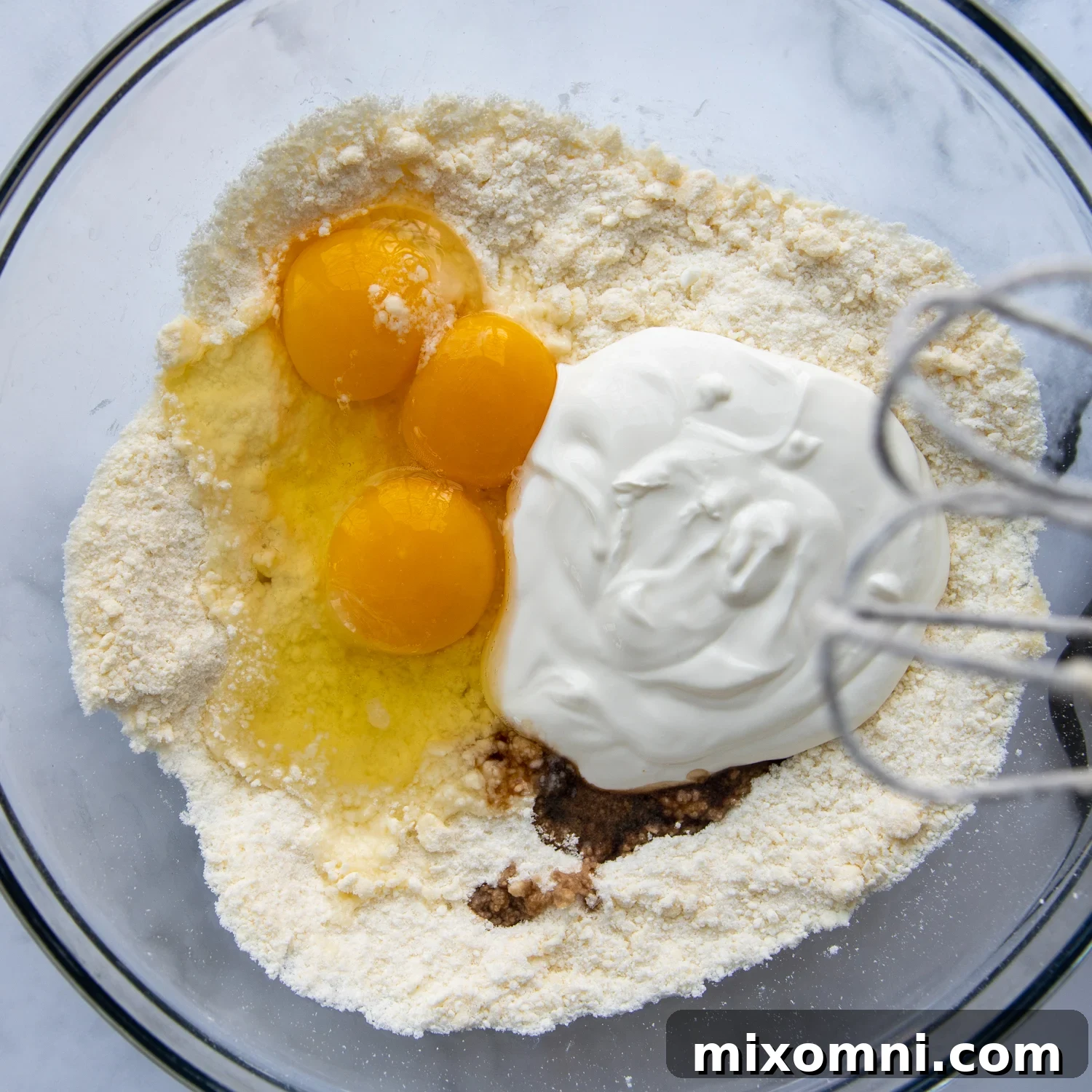Sour cream and eggs are beaten into the dry ingredients to create a moist gluten-free coffee cake batter.