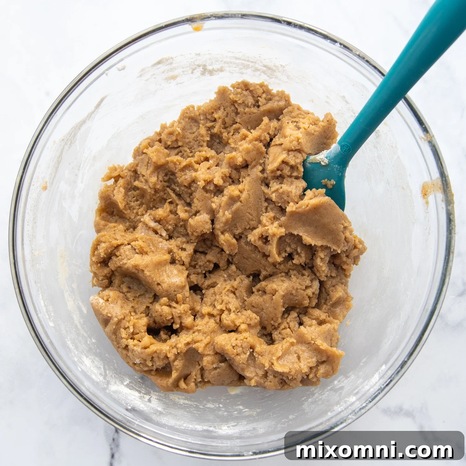 A small glass bowl filled with the thick, buttery cinnamon streusel topping for coffee cake.