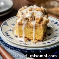 A slice of gluten-free coffee cake with frosting on top dripping down