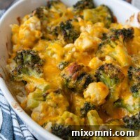 close up of melted cheese on broccoli and cauliflower in a casserole dish