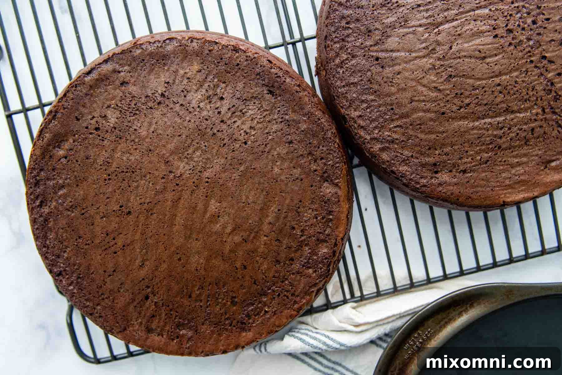 Freshly baked gluten-free chocolate cakes cooling on a wire rack.