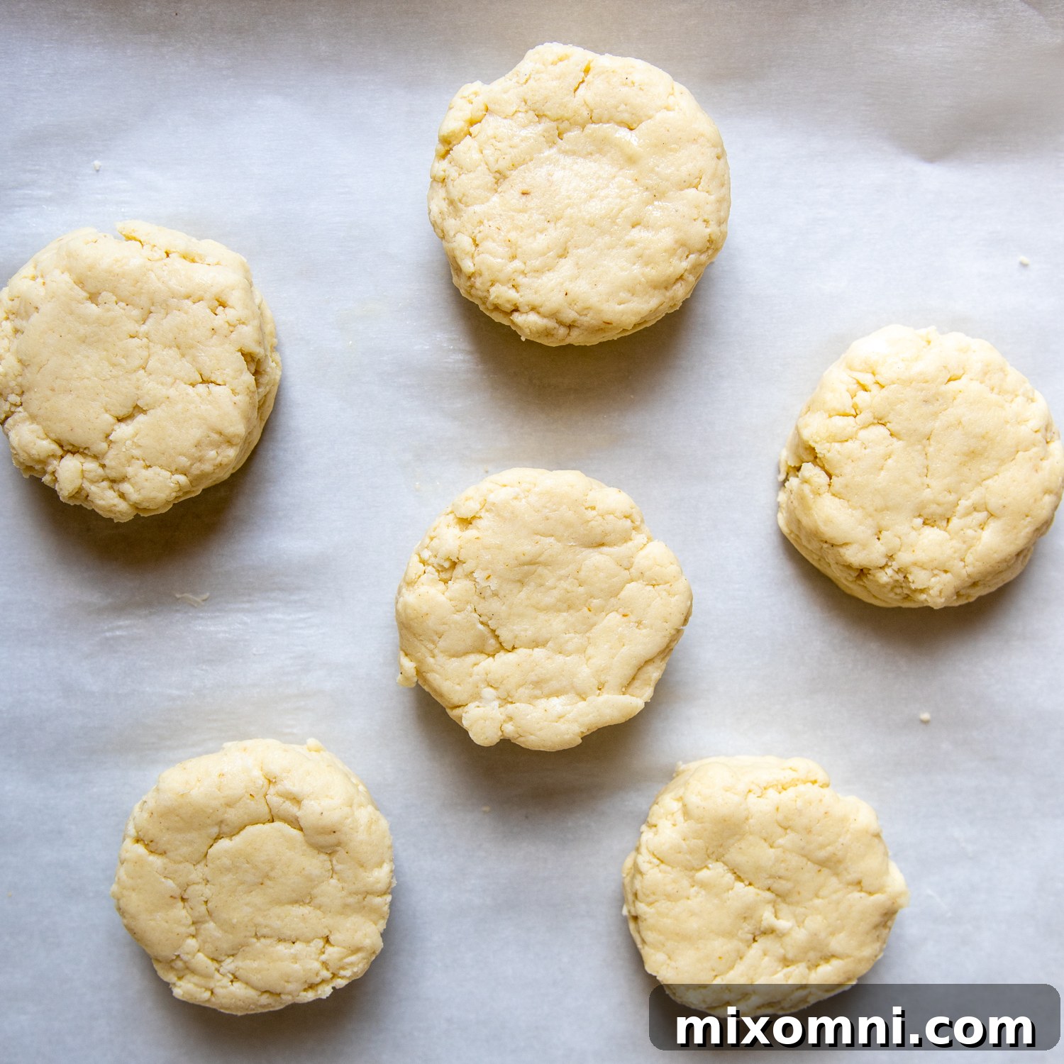 unbaked biscuits on a baking sheet.