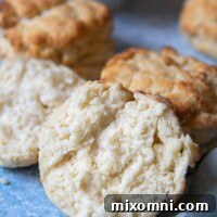 a split open biscuit with jam behind it