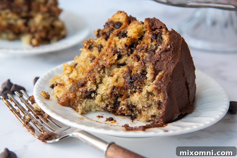A delicious slice of Carmelita cake on a white plate with a bite taken out, showcasing the layers.