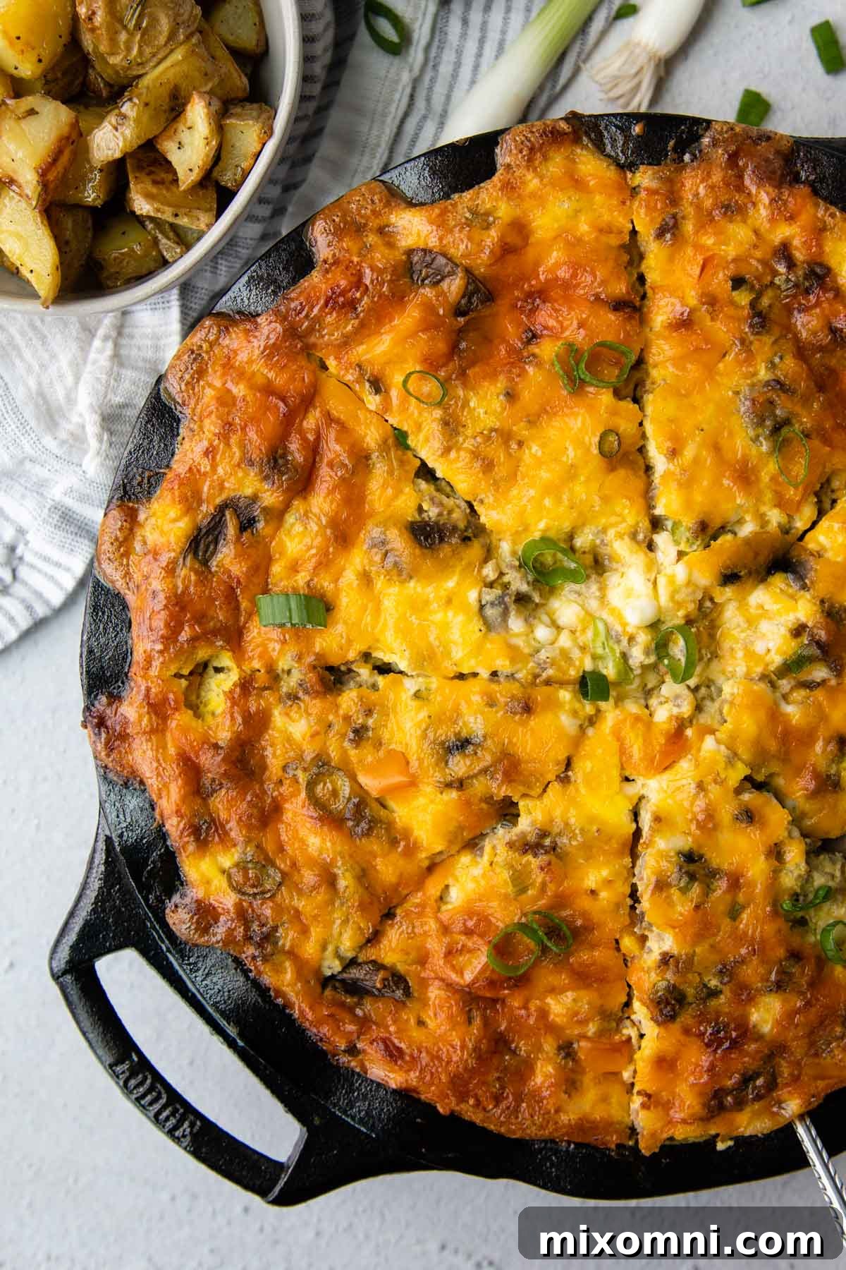 an overhead shot of a whole quiche, cut into slices.