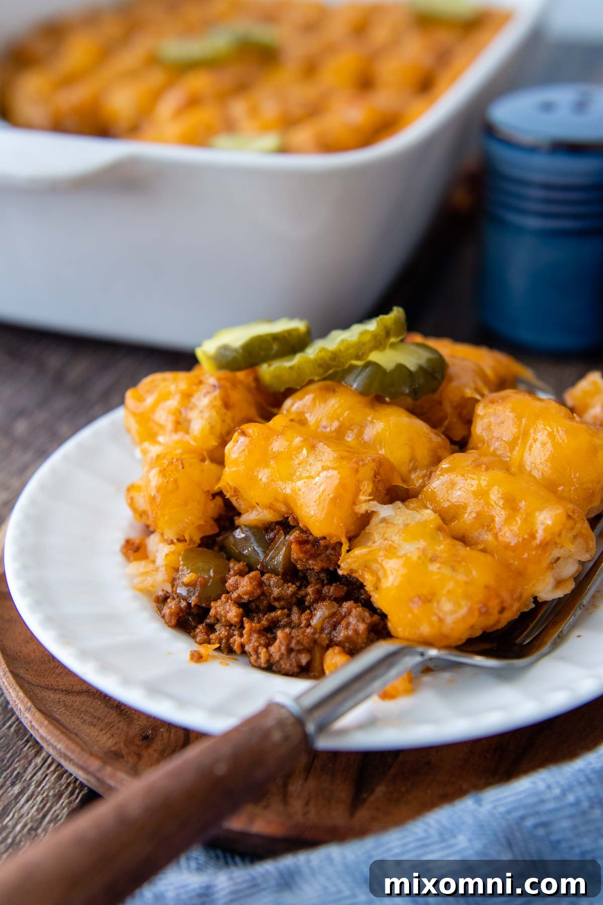 a serving of casserole on a white plate with a fork resting on it