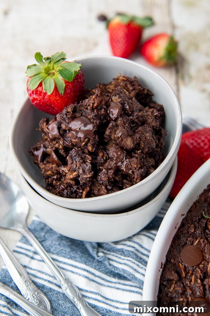 a double stacked bowl of chocolate oatmeal with a blue striped towel underneath