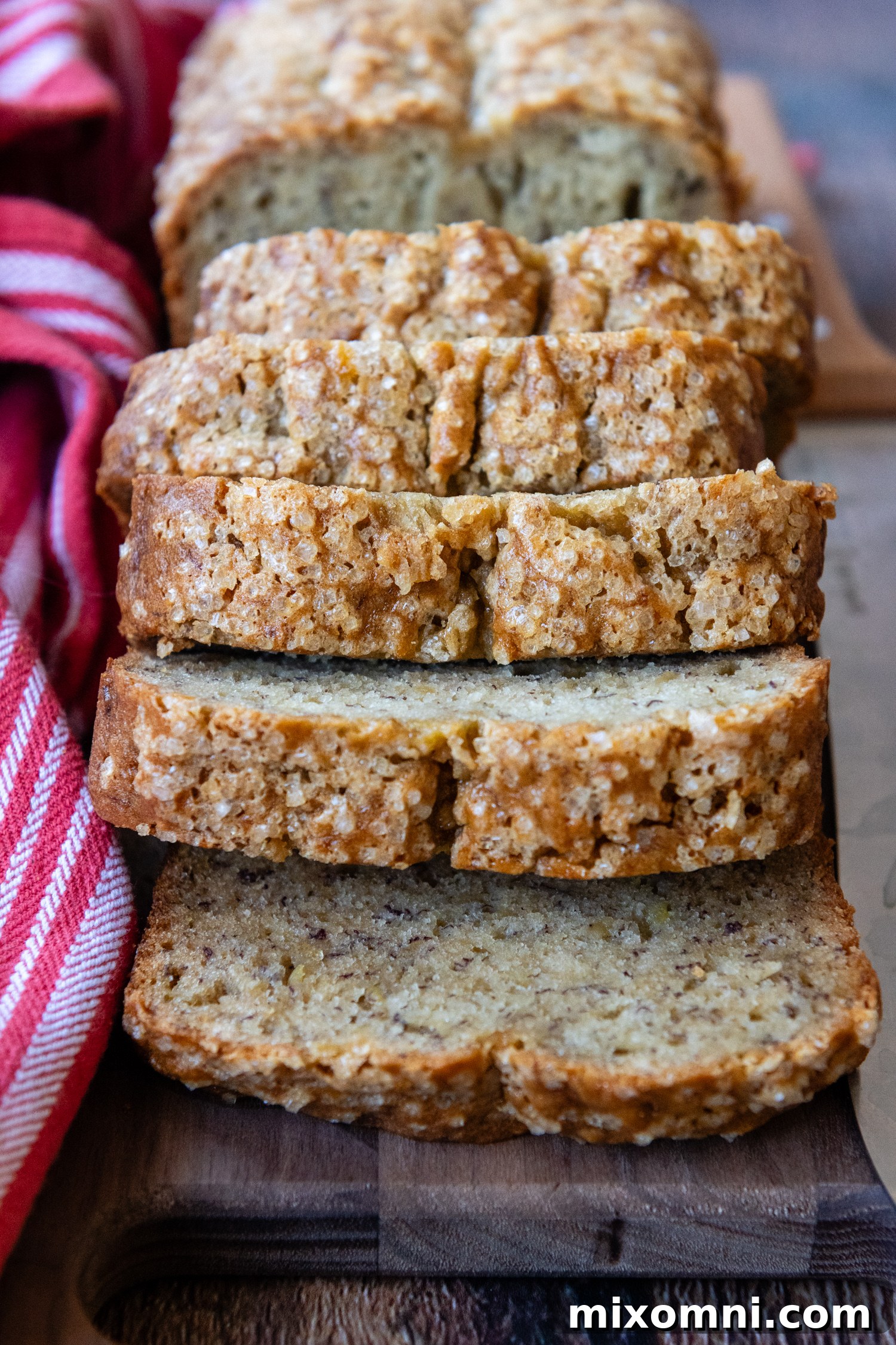 bread slices falling down on a wooden cutting board.