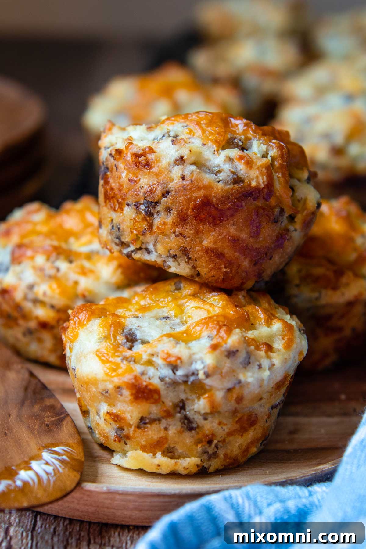 two muffins stacked on top of each other on a wooden plate