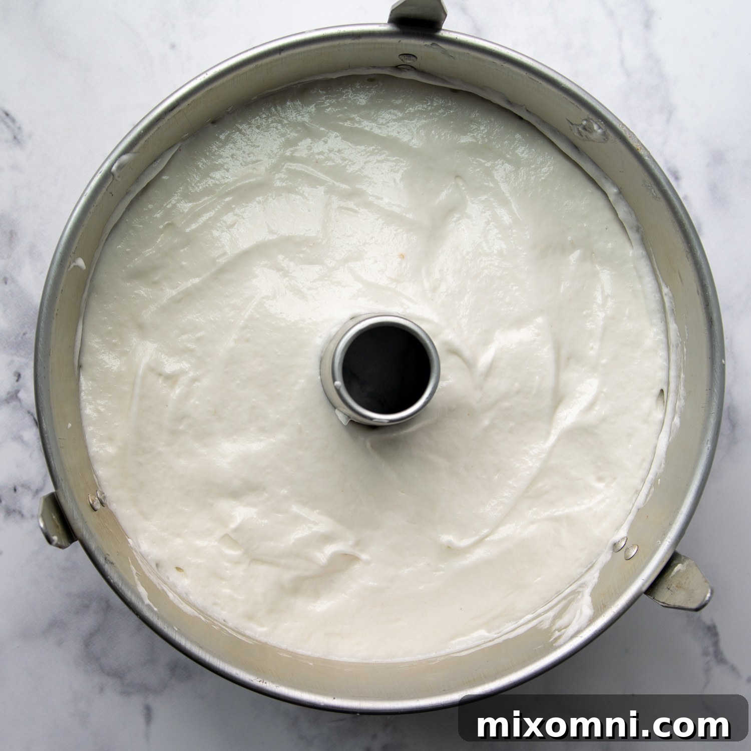 The cake batter filled into an ungreased tube pan, ready for baking.