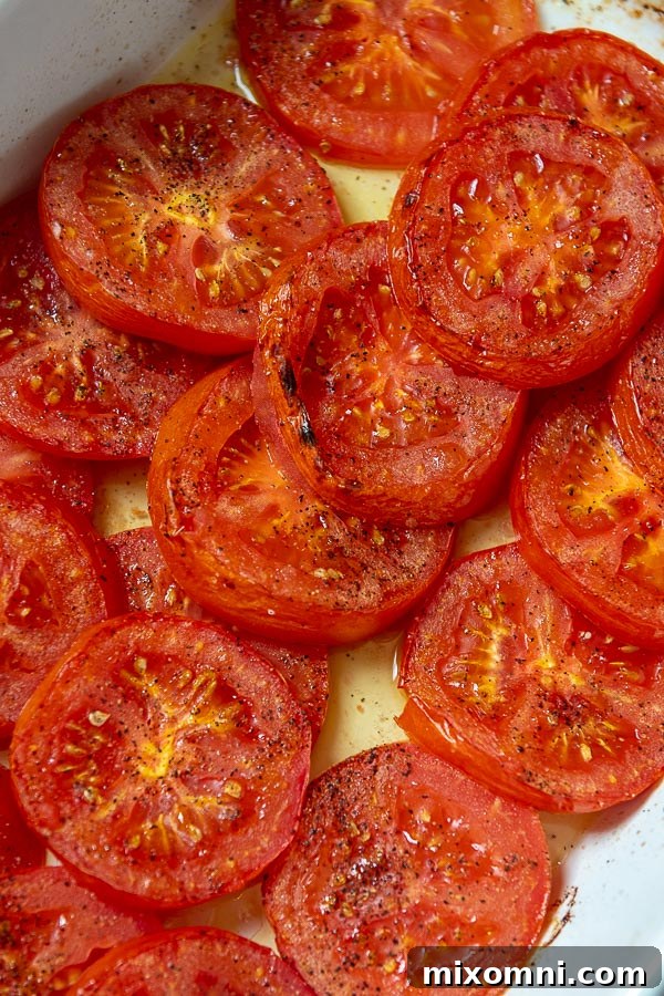 Charred, oven roasted tomato slices drizzled with olive oil and seasoned with salt and pepper