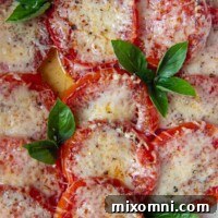 A pan of baked tomatoes with broiled cheese on top