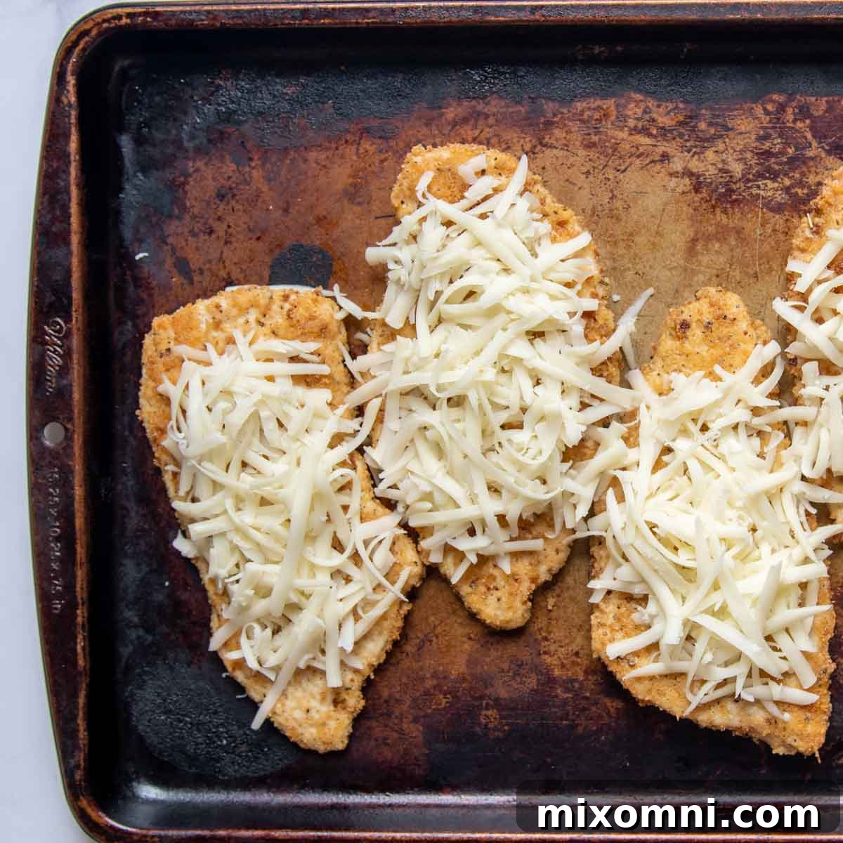 baked chicken with mozzarella cheese on top.