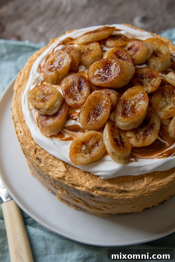 Overhead shot of a beautifully decorated banoffee cake topped with golden sauteed bananas, ready to be served.