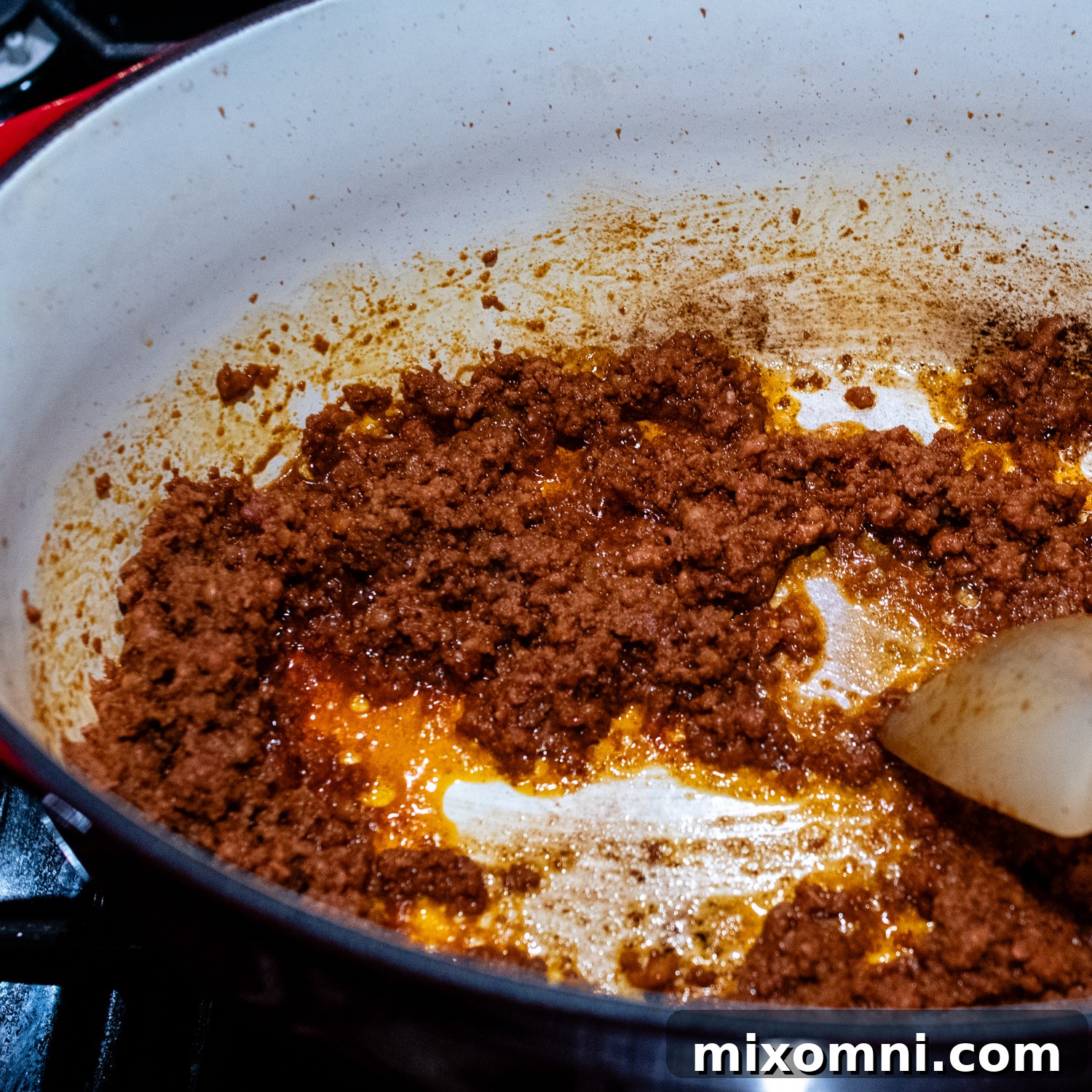 Mexican chorizo sausage being cooked in a large pot, broken into crumbles.