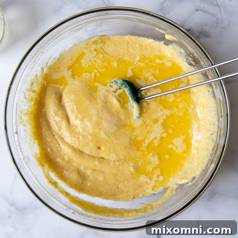 bowl of cornbread batter with melted butter
