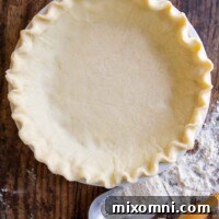 overhead shot of gluten free pie crust on a wooden surface.