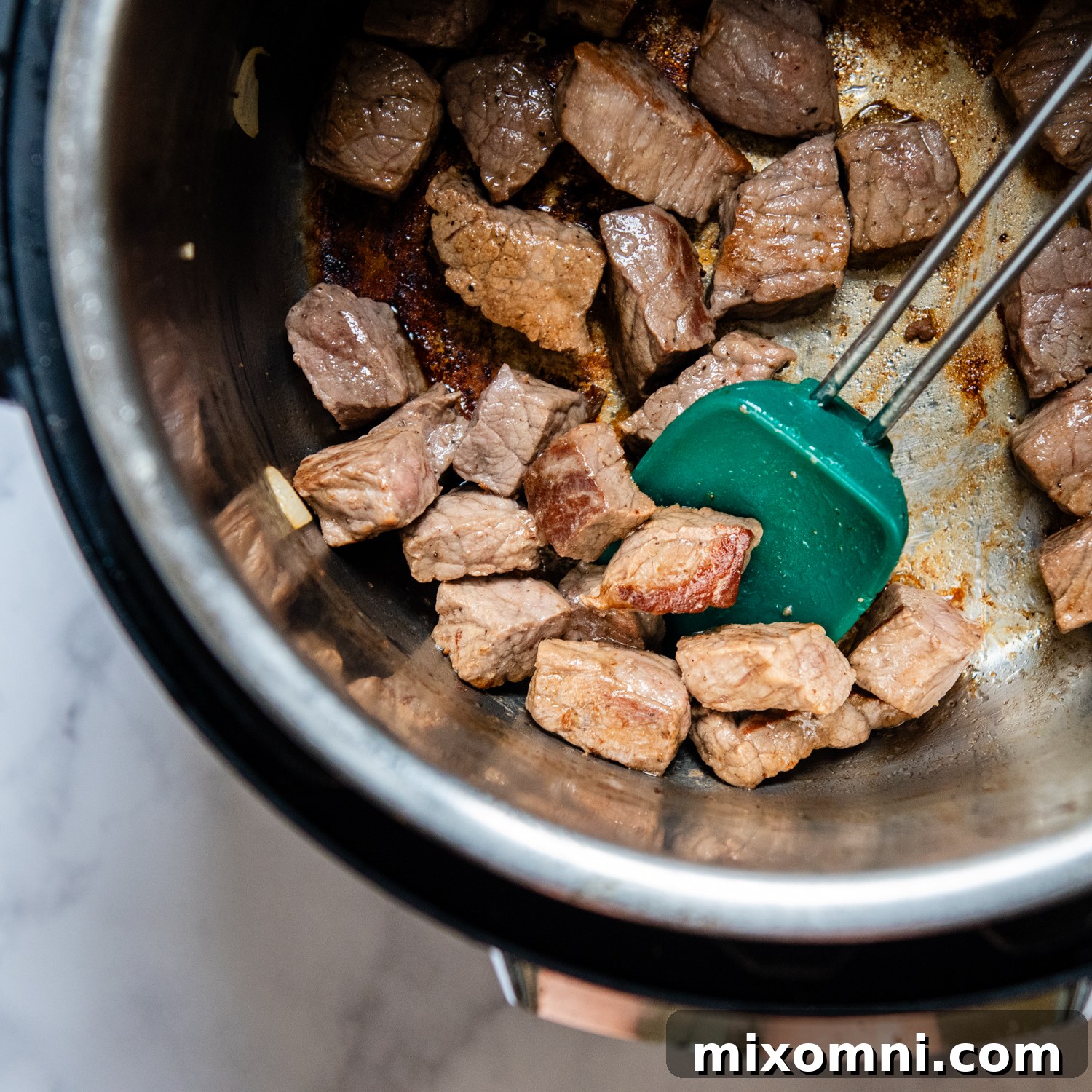 beef being browned in the pressure cooker.