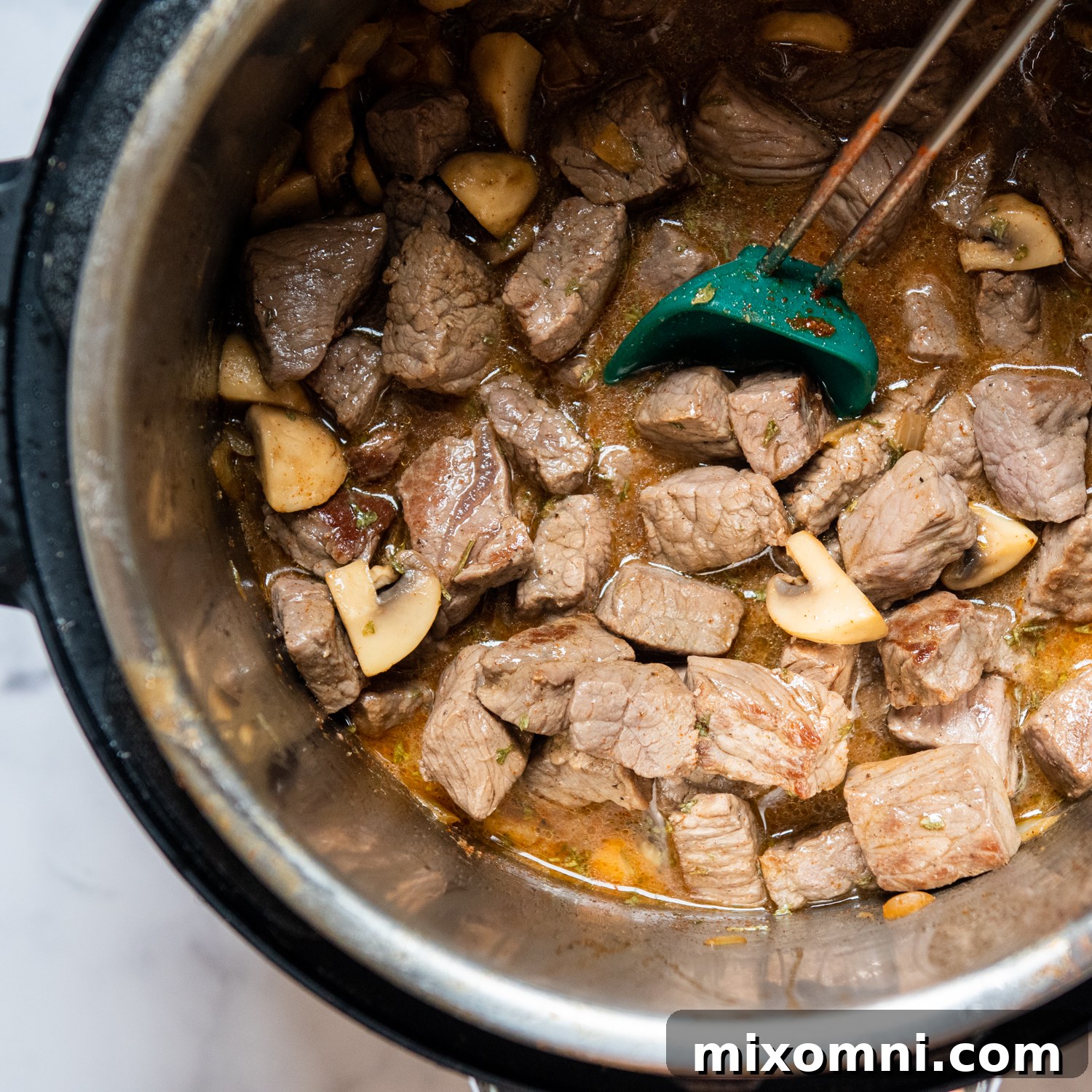 beef being browned in the pressure cooker.