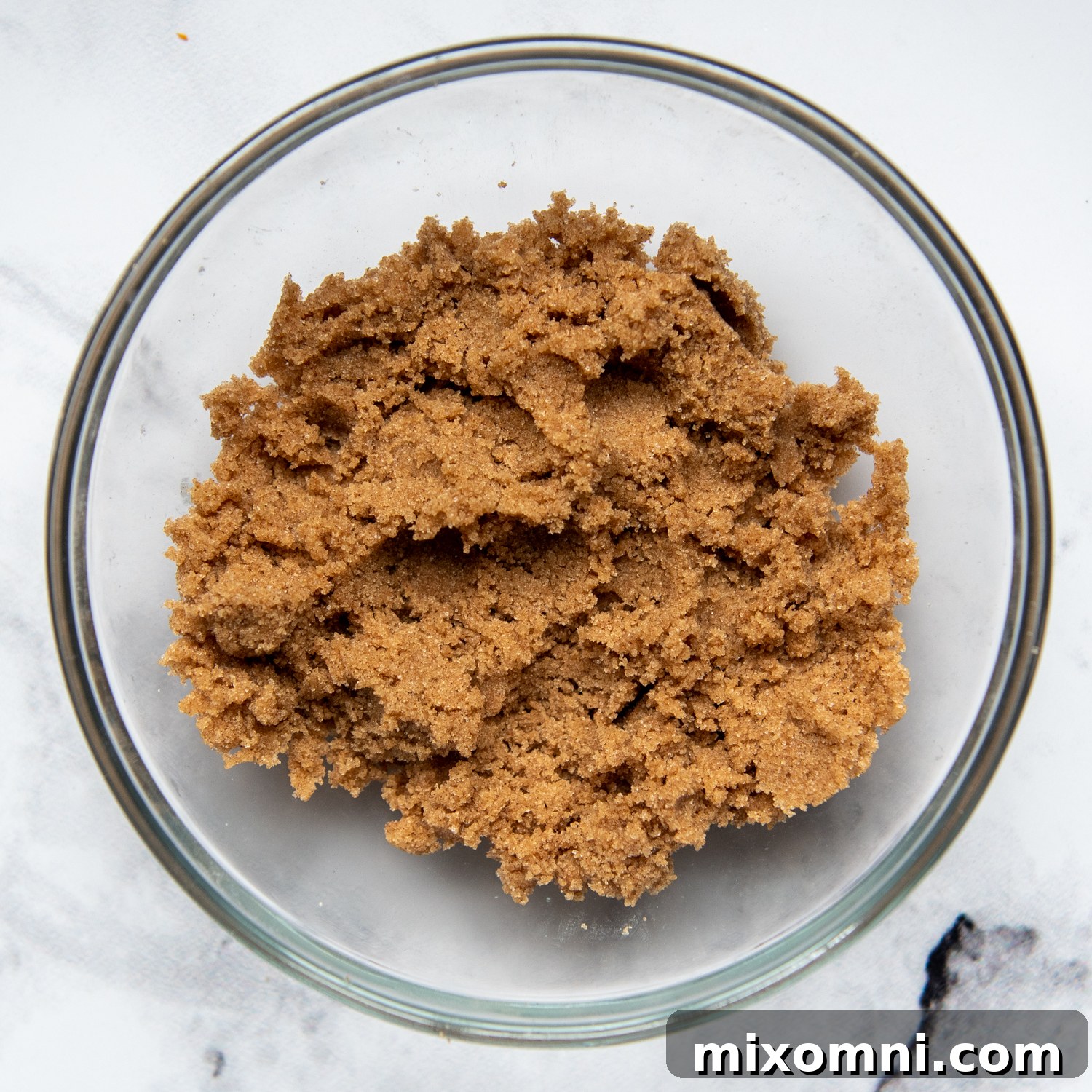 A small bowl containing streusel topping ingredients for pumpkin bread, showcasing the crumbly texture.