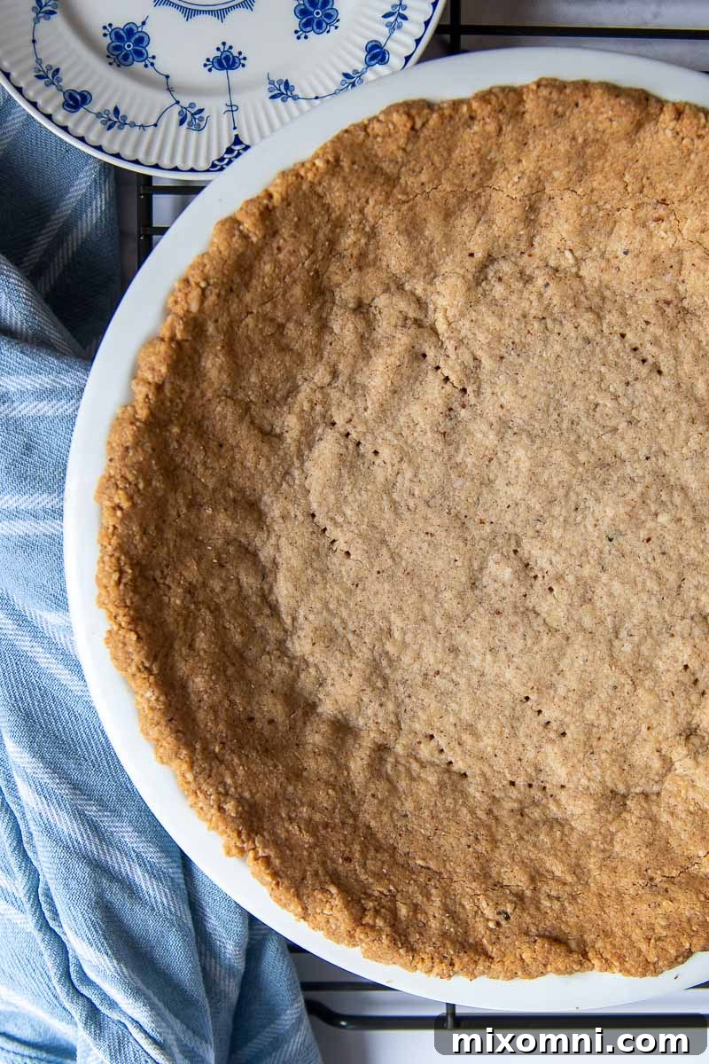 overhead of pie crust made from pecans in a pie plate