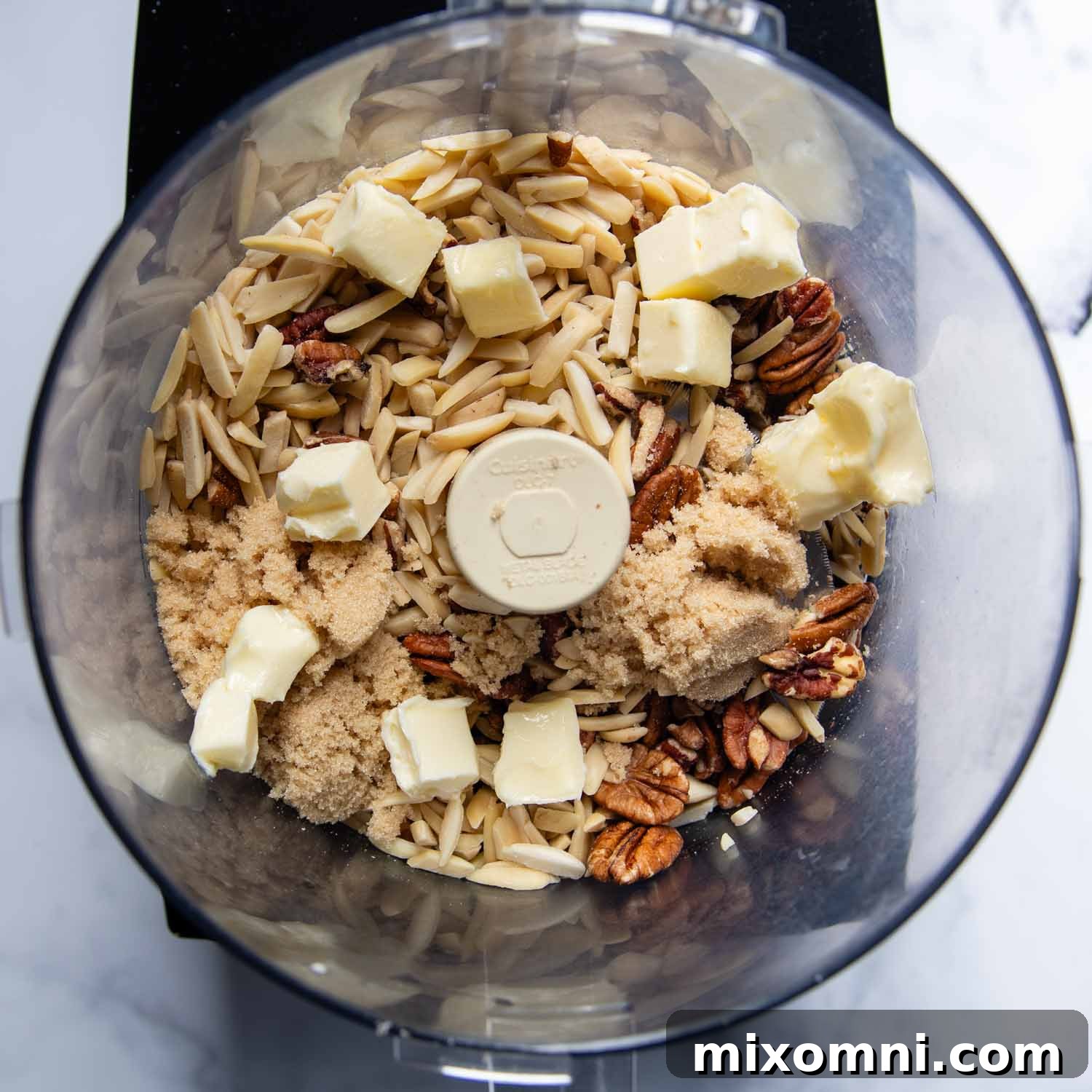 the nuts with softened butter and sugar in a food processor.