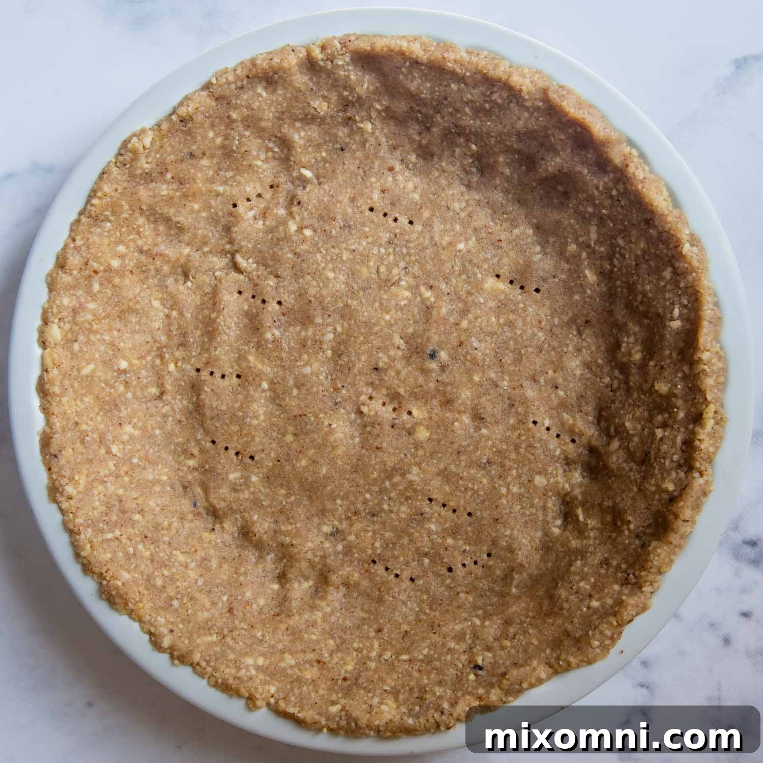 the nut crust pressed into a pie pan, unbaked.