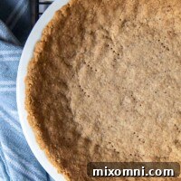 overhead of pie crust made from pecans in a pie plate