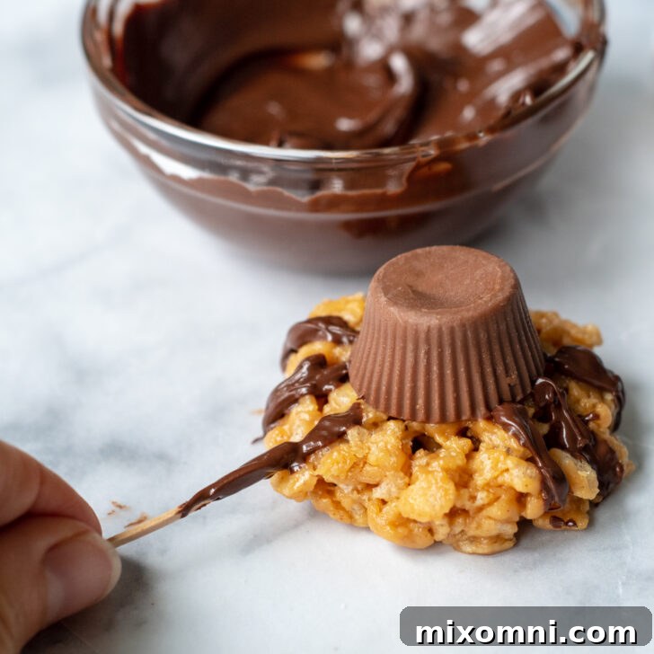 A toothpick delicately painting on spider legs with melted chocolate onto a cookie, detailing the decoration process.