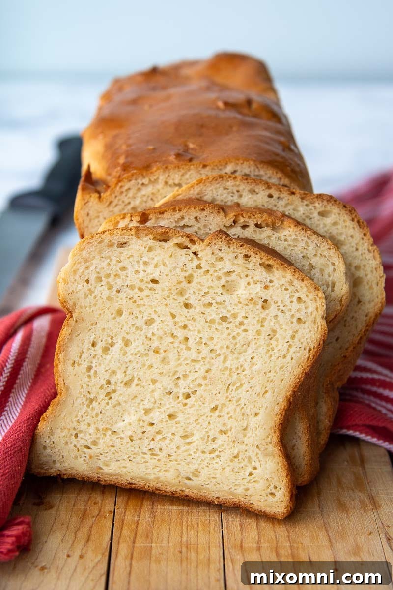 Slices of fluffy gluten-free bread arranged on a rustic wooden cutting board, ready to be enjoyed.