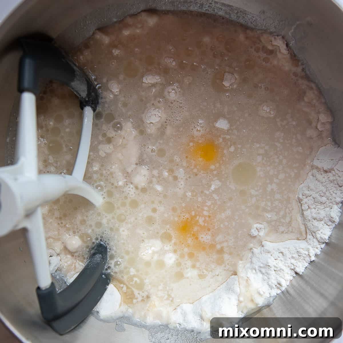 Dry ingredients in a mixing bowl, with wet ingredients ready to be added, illustrating the first step of the recipe.