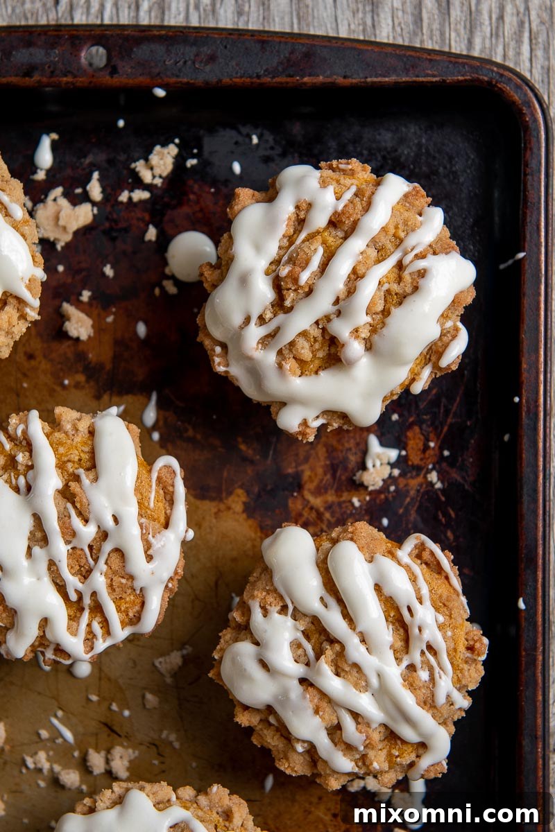 overhead shot of pumpkin muffins with cream cheese glaze drizzled over top