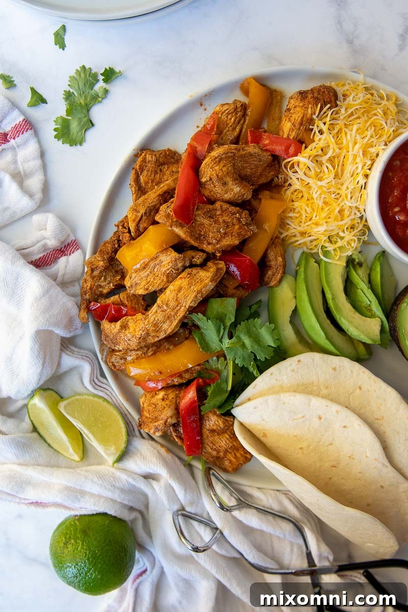 Overhead shot of Instant Pot chicken fajita meat with onions and peppers, freshly cooked and vibrant.
