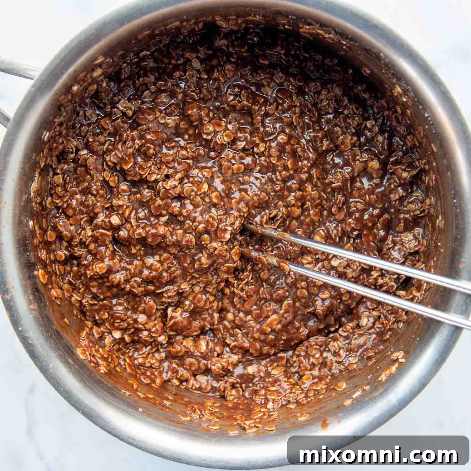 The mixed Preacher Cookie ingredients in a saucepan after boiling and adding oats and peanut butter.