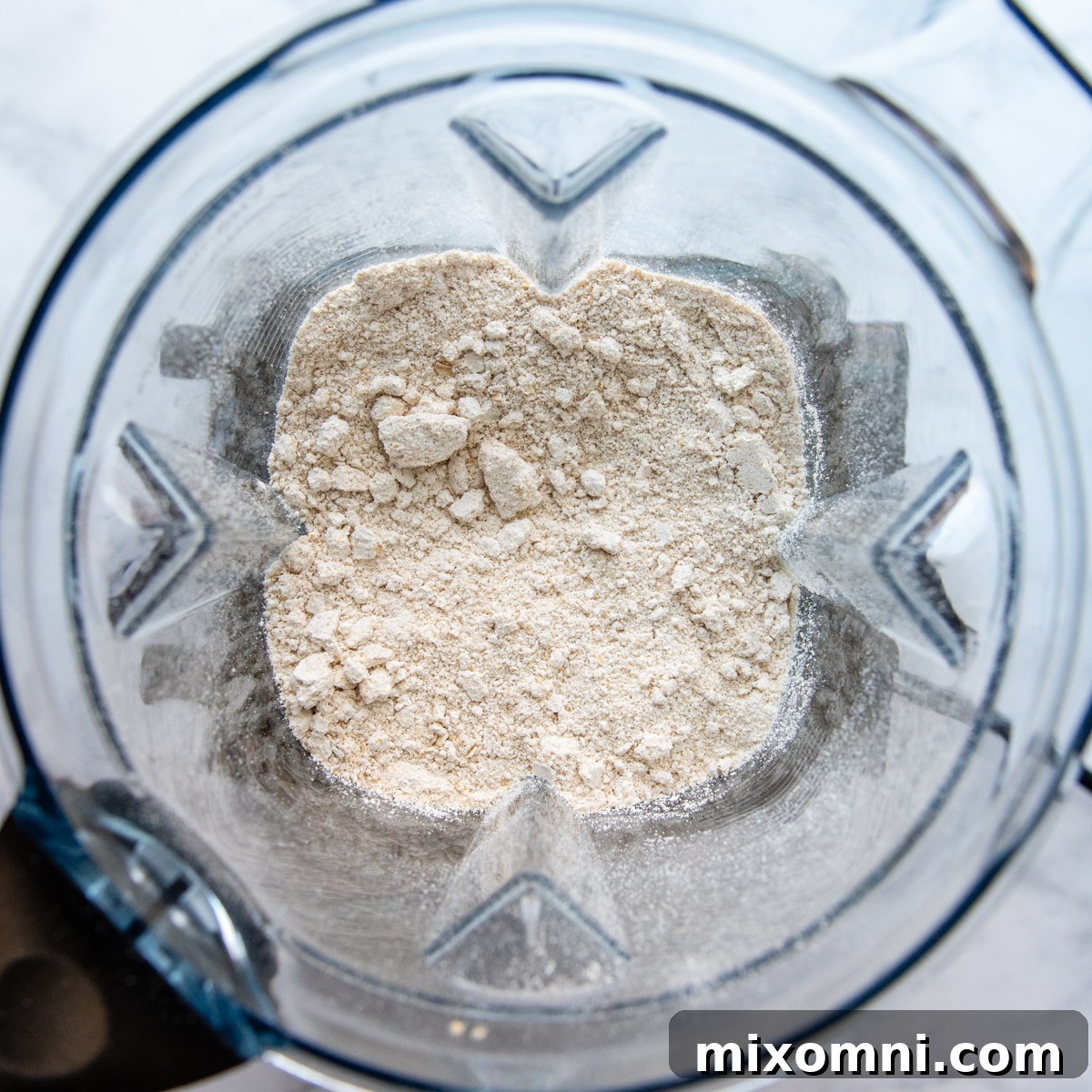 Finely ground oat flour in a blender after processing whole oats.