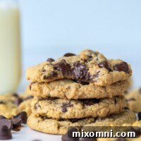 A stack of oat flour cookies with a bite taken out of the top one, showcasing soft, chocolatey goodness.