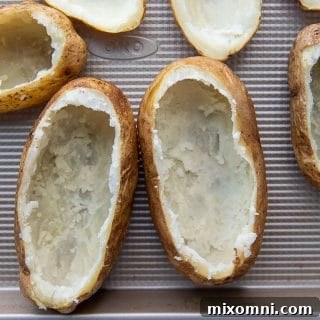 Potatoes with their fluffy interior carefully removed, leaving a sturdy shell.
