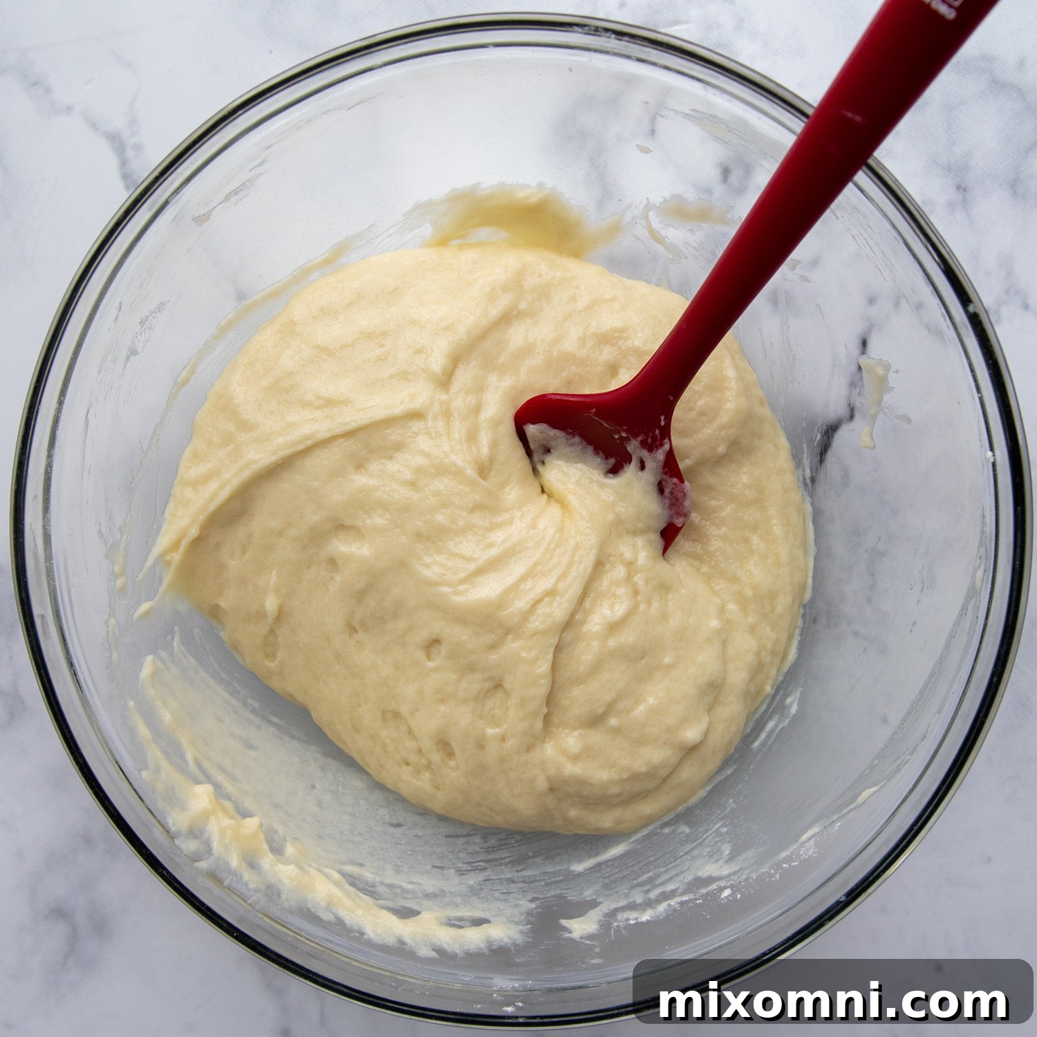 Wet ingredients being stirred into dry ingredients to form the bread dough.