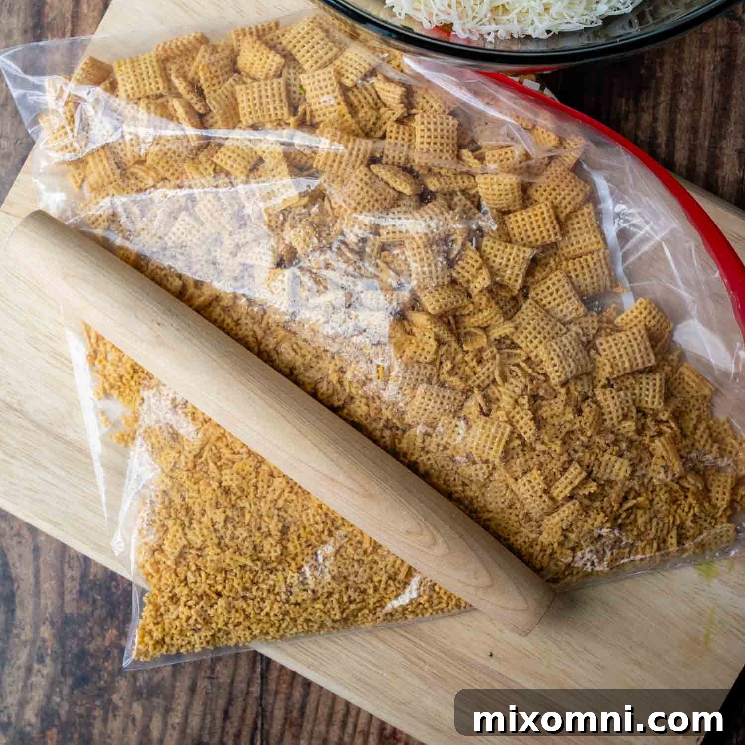Crushing corn Chex cereal in a ziplock bag with a rolling pin, an alternative to breadcrumbs.