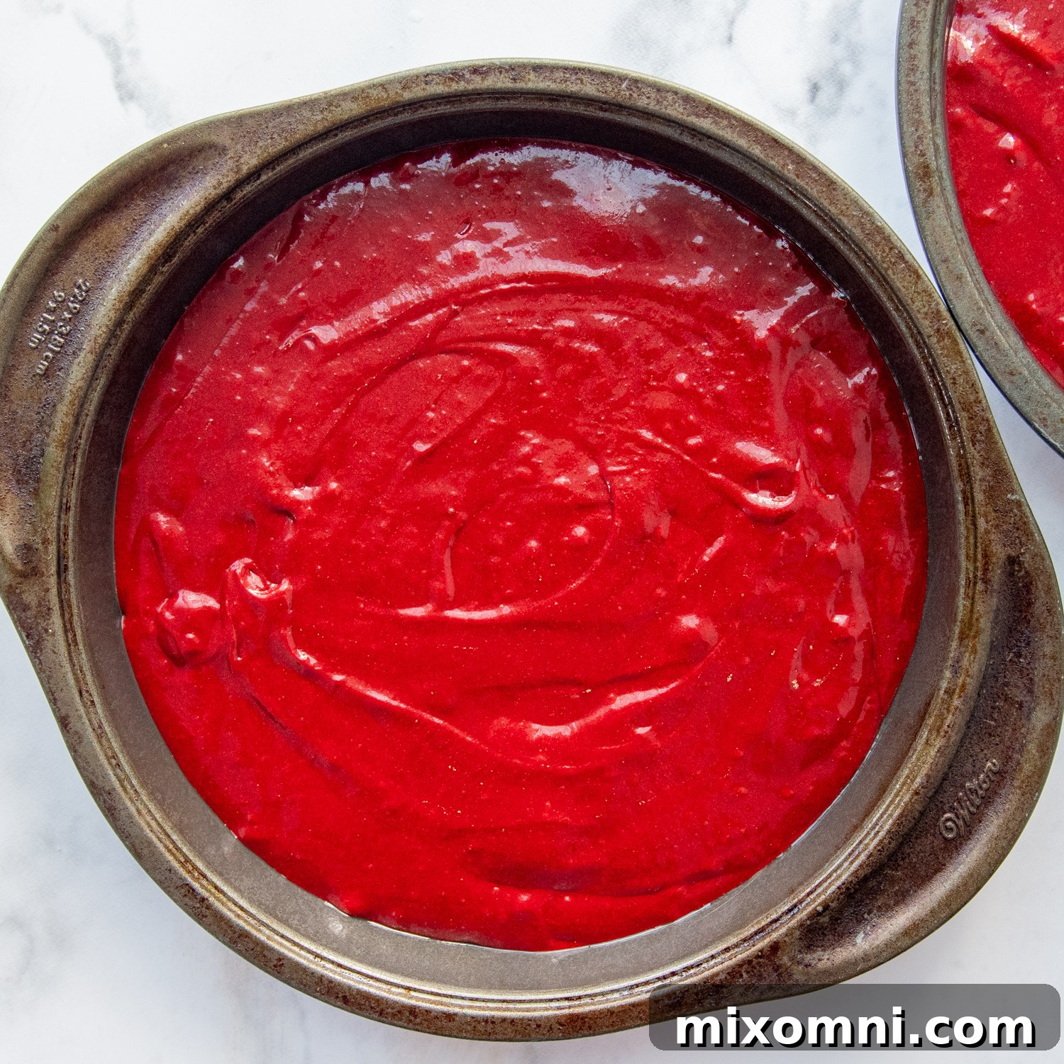 the cake batter in the cake pans before baking.