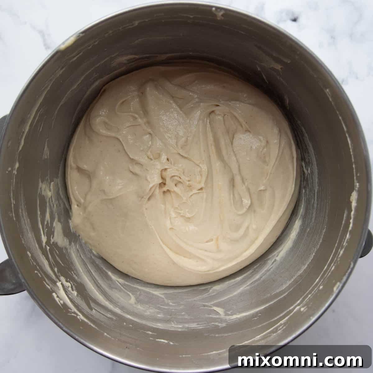 Gluten-free challah bread dough neatly scraped into a bowl, covered and ready for its overnight rise.