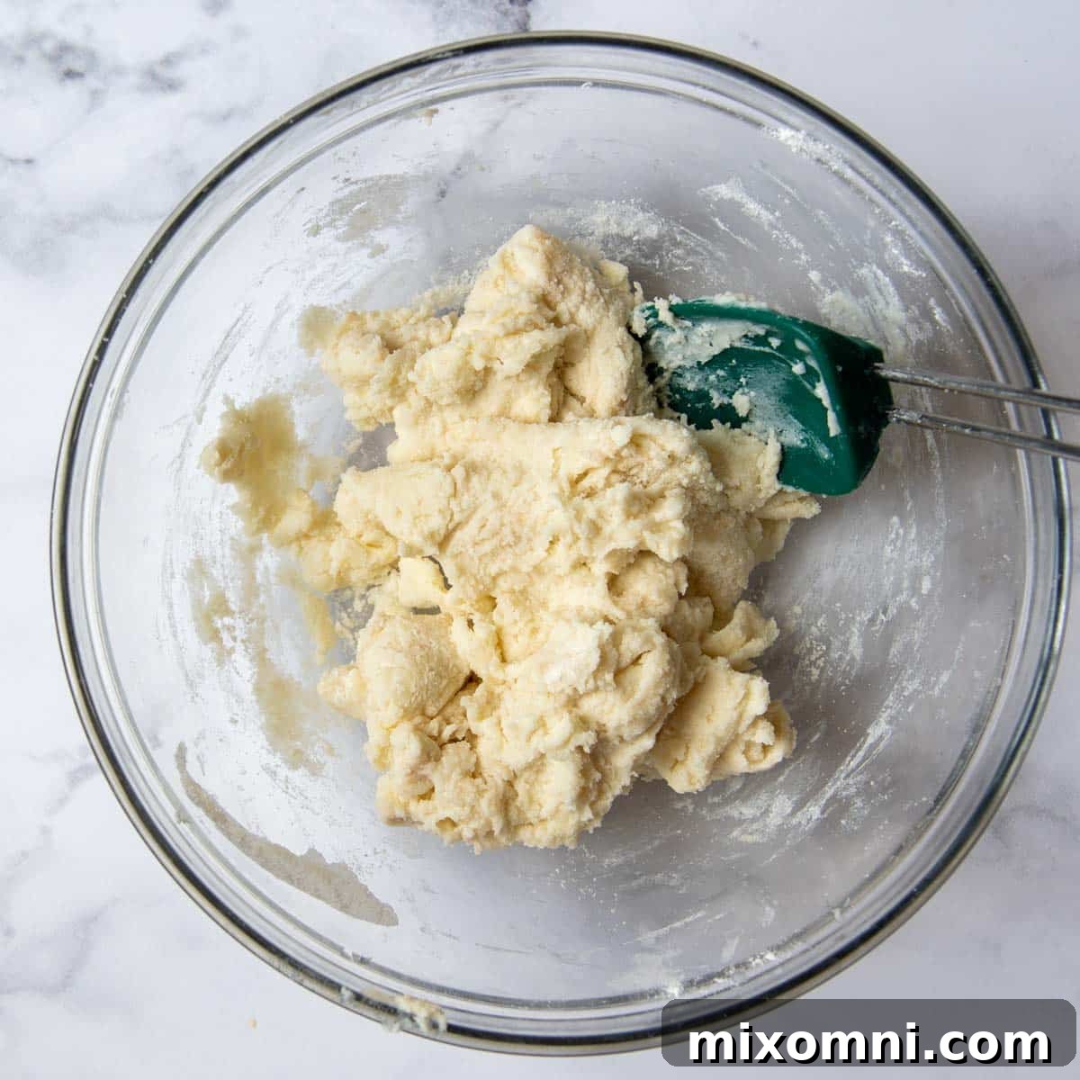 The prepared gluten-free cobbler topping dough, stiff yet soft, resting in a glass bowl, showcasing its readiness for baking.