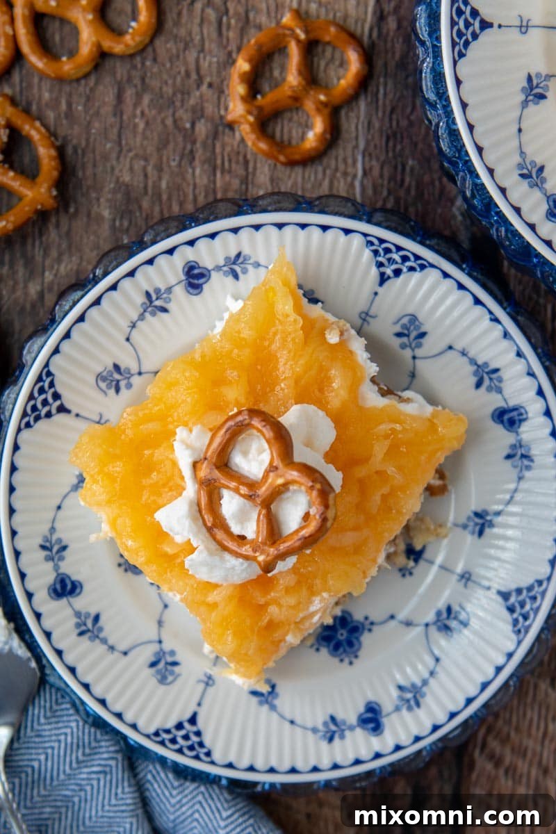 A beautifully composed slice of Pineapple Pretzel Salad, showcasing the distinct layers and inviting texture.