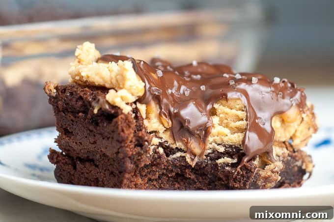 A perfectly portioned Buckeye Turtle Brownie resting on a plate, with a satisfying bite already taken, revealing its rich, layered interior.