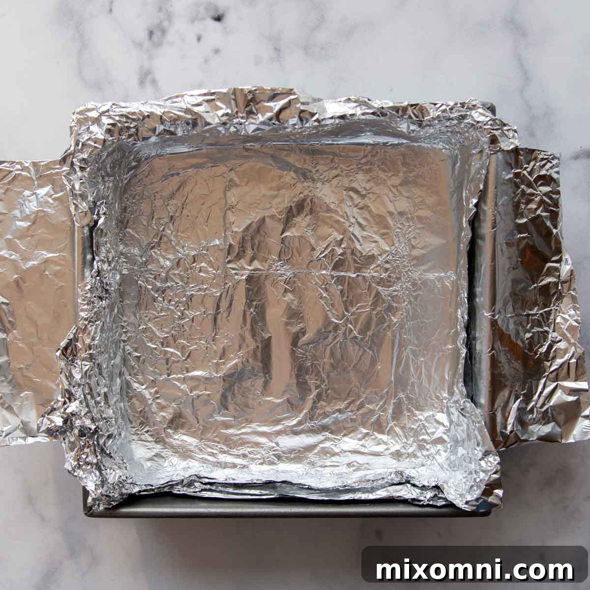 An empty baking pan lined with foil.