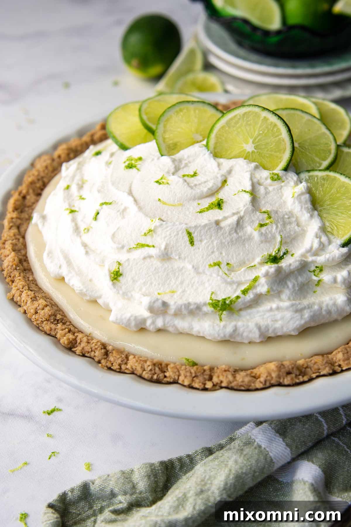 key lime pie with oat flour crust and green linen next to it