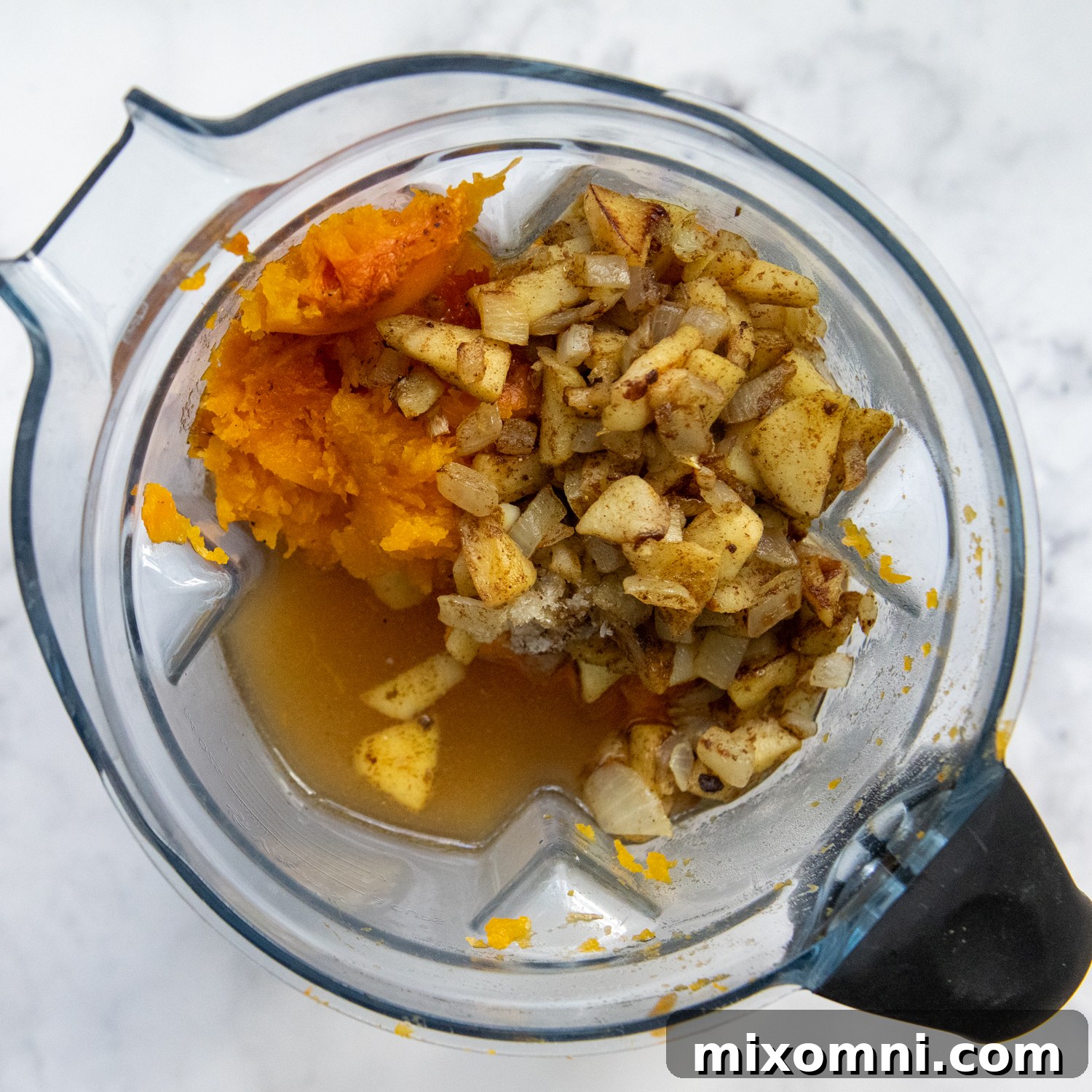 the squash, apples and onions about to be puréed in a blender.