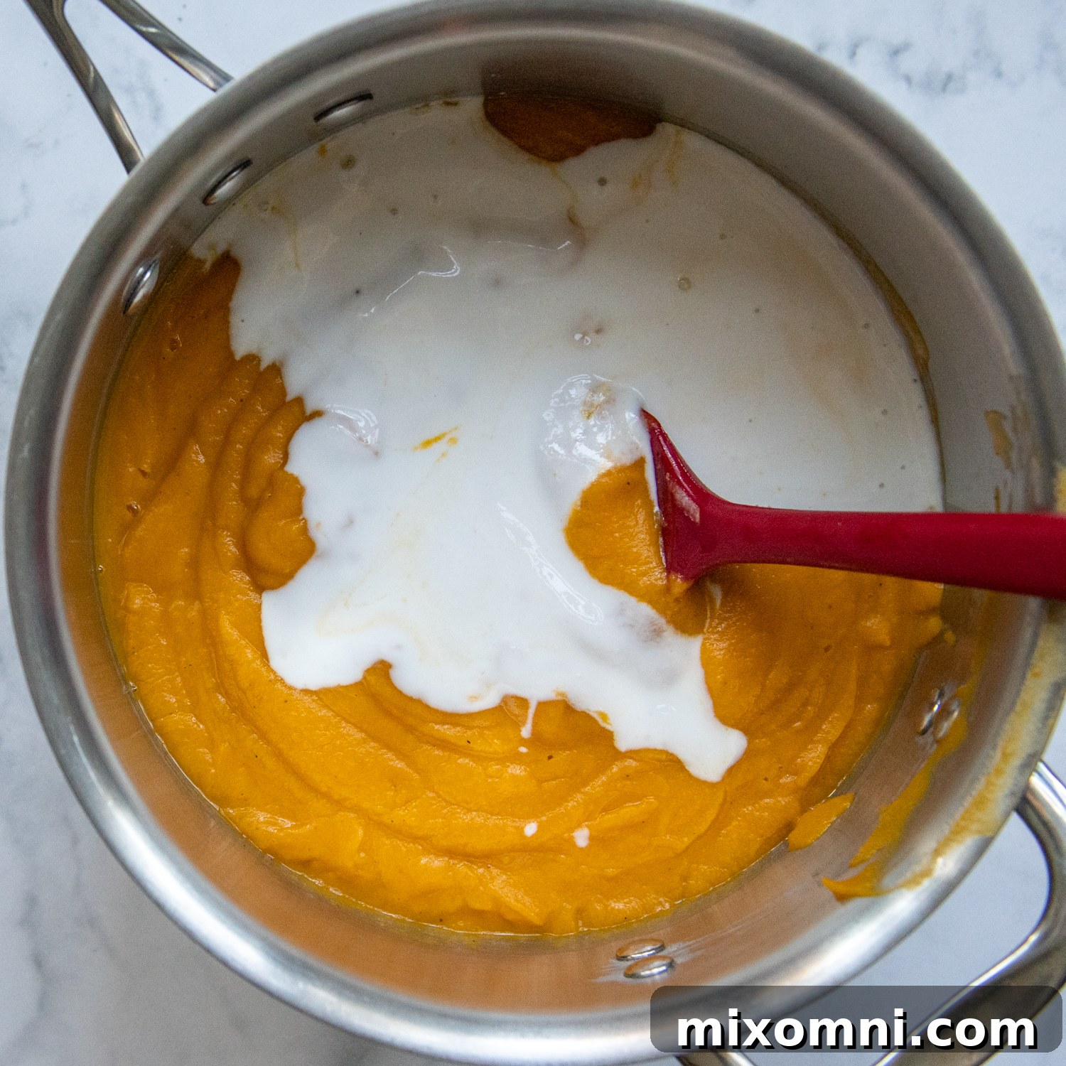 coconut milk added to the saucepan with soup.