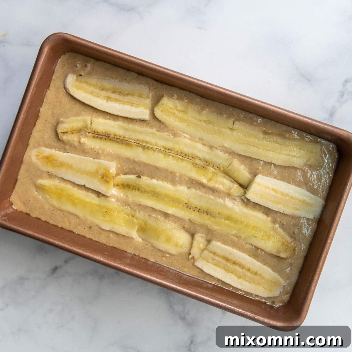 image showing unbaked bread with sliced bananas on top