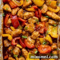 overhead shot of gluten free sweet and sour chicken in a white baking dish
